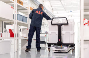 a human loads boxes onto an ABB AMR.