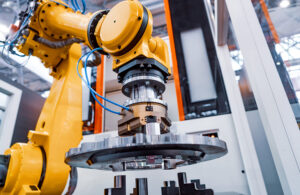 industrial robot moves a heavy steel plate.