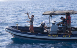 Project CETI boat with people interacting with drones.