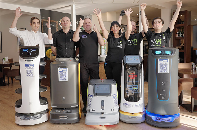 Parkhotel employees in Eisenstadt, Austria, celebrate the arrival of Pudu's service robots.