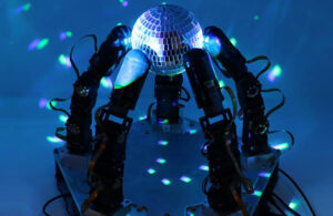 Columbia University's robotic hand with five fingers holding a disco ball.