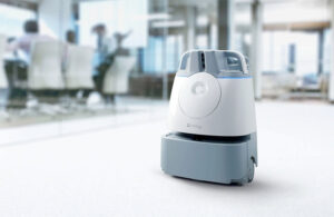 A SoftBank Whiz commercial floor cleaning robot in a corporate office.